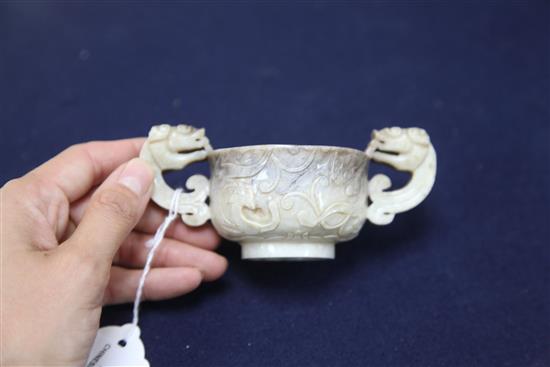 A Chinese cream and black jade two handled cup, 16th/17th century, width 13cm